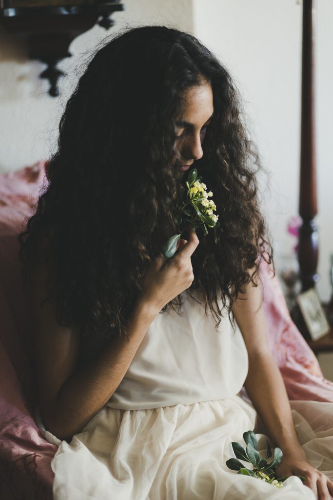 beautiful woman smelling flower